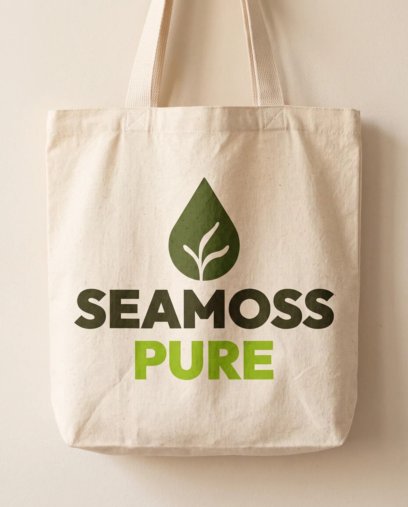 A natural cotton tote bag screen-printed with the stacked logo.