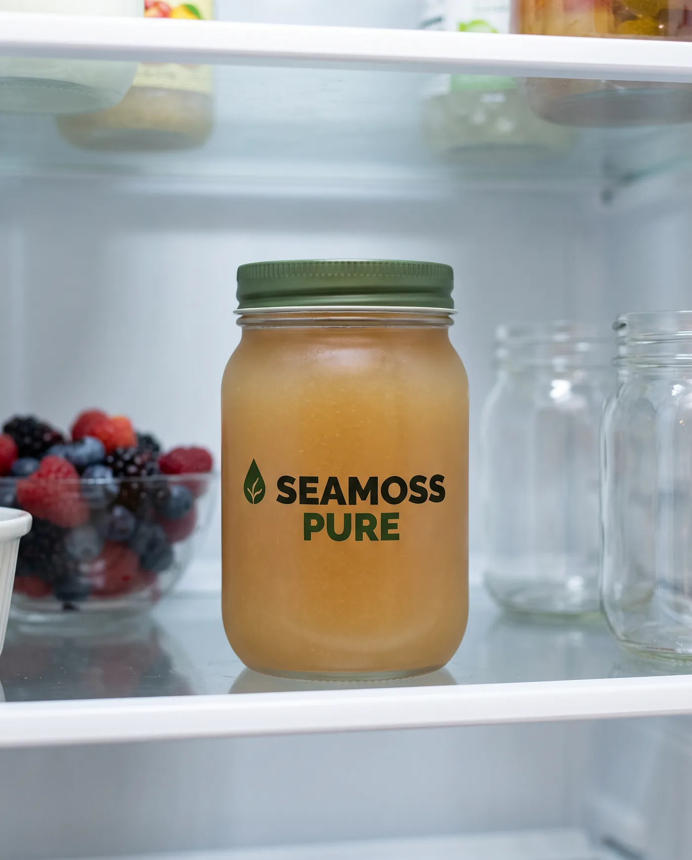 A jar of sea moss gel on a refrigerator shelf.